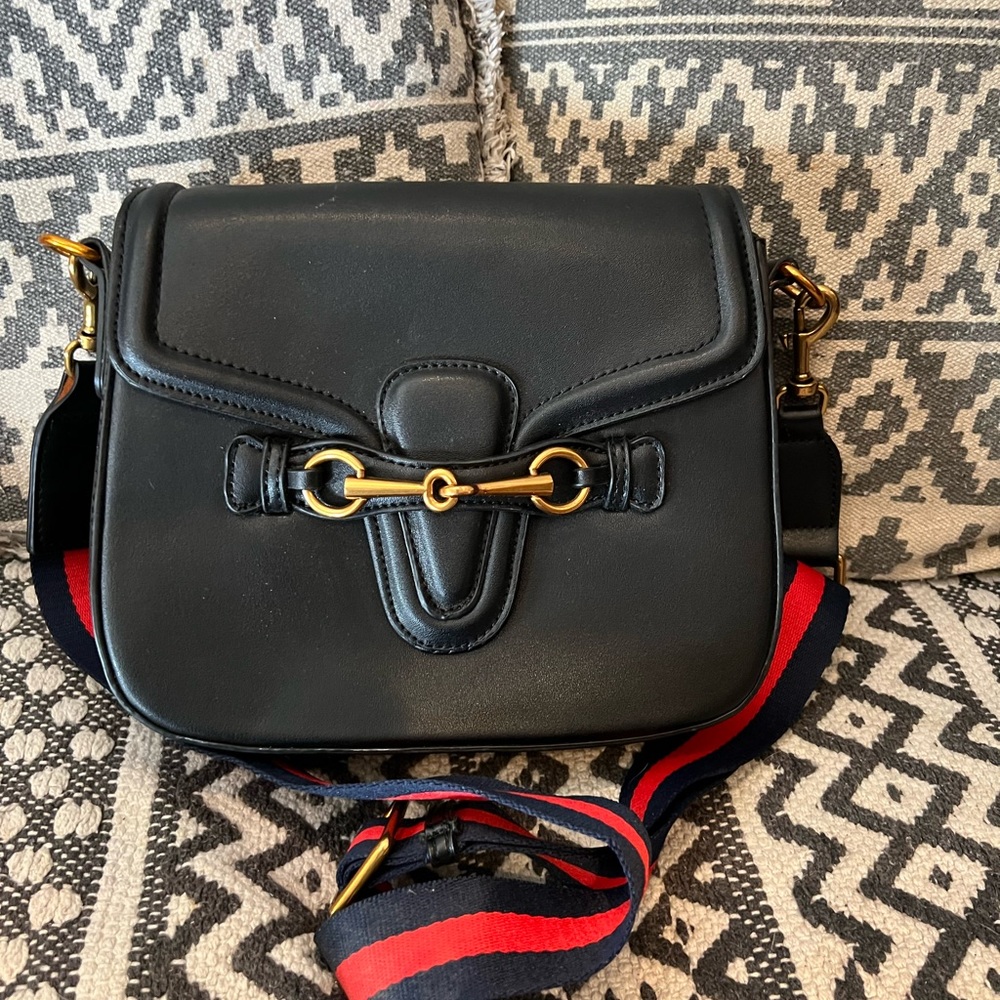Black, unbranded small saddle purse.